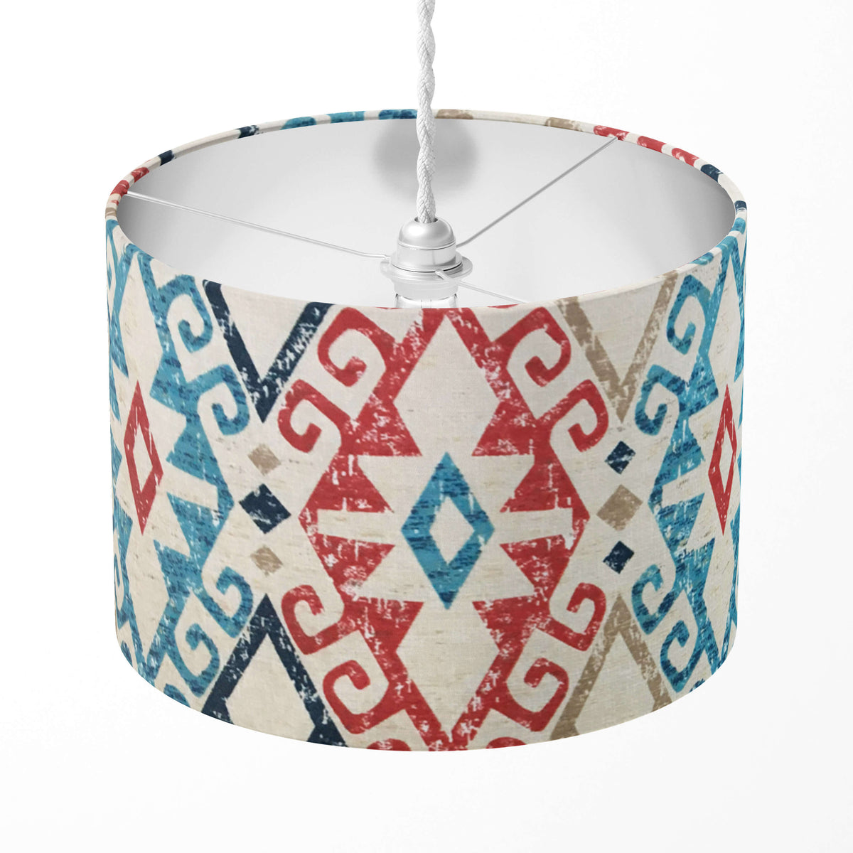 Aztec lampshade with red, blue and navy geometric pattern on a white background.