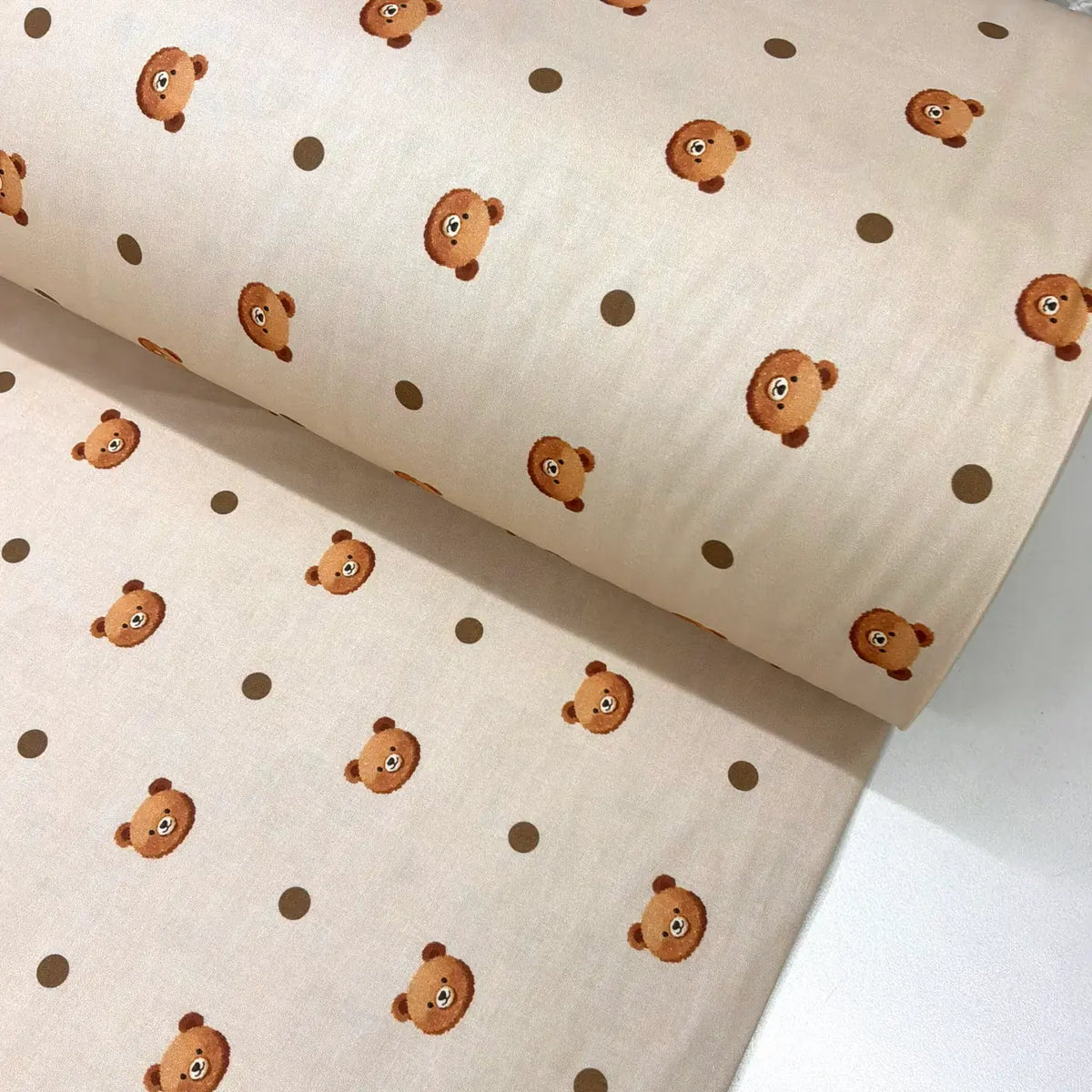 Beige cotton poplin fabric with cute bear faces and brown polka dots, suitable for children's dressmaking, quilting, nursery sewing and baby craft projects.