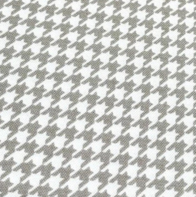 Light brown and white dogtooth print cotton canvas upholstery fabric.
