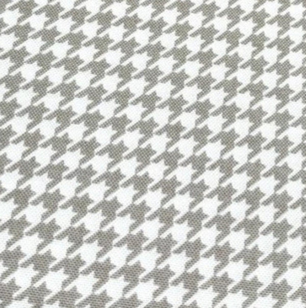 Light brown and white dogtooth print cotton canvas upholstery fabric.