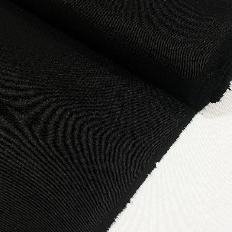 Black cotton duck canvas fabric with a tightly woven texture, suitable for upholstery, curtains, chair covers, bags, and outdoor projects.