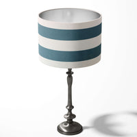 Table lampshade with horizontal teal blue and white stripes on a white background.