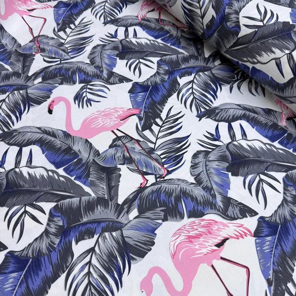 Upholstery fabric with pink flamingo and navy blue and grey leaves pattern.