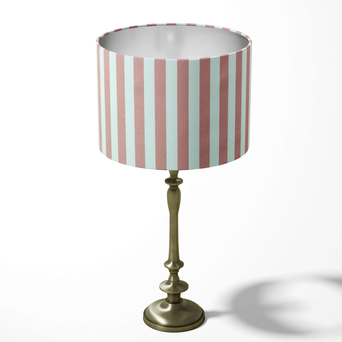 Dusky pink and white pink striped table lamp shade on a white background. 