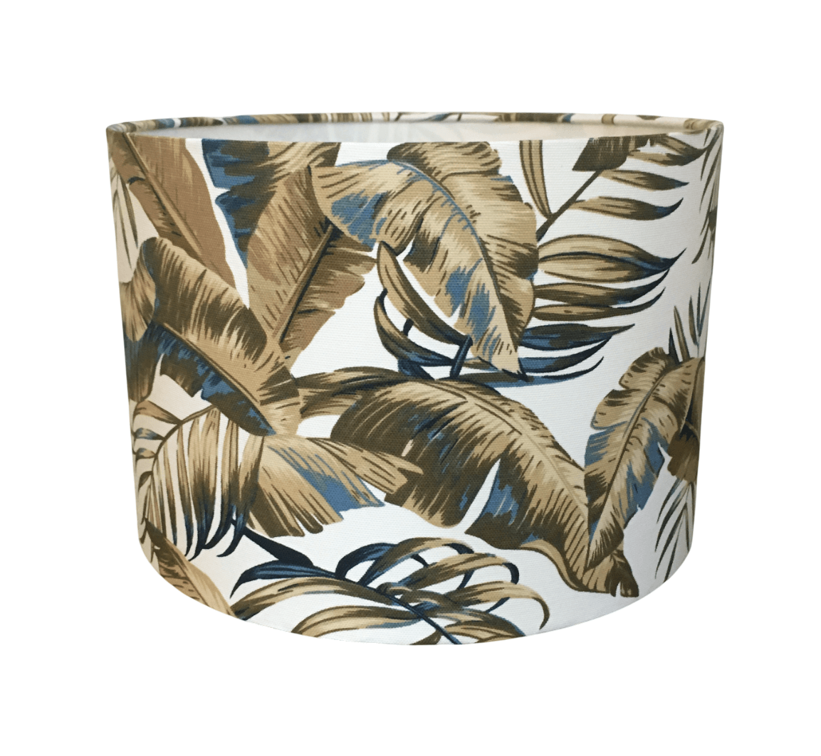 Decorative lampshade with a brown and indigo blue tropical leaf pattern on a white background.