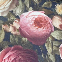 Close-up of burgundy roses and sage green leaves fabric.