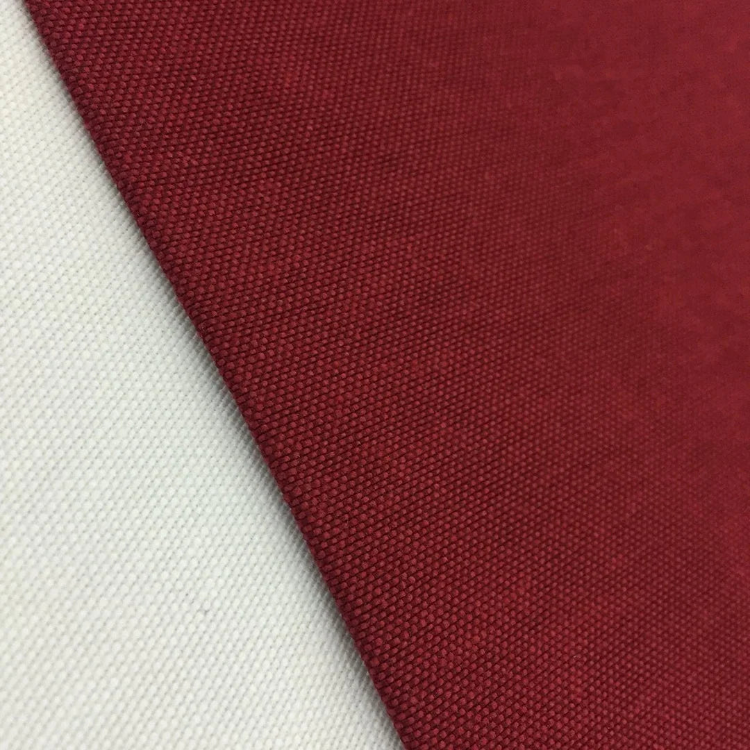 Burgundy cotton canvas fabric with a plain woven texture, ideal for upholstery, curtains, cushions, bags, crafts, and soft furnishing projects.