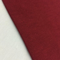 Burgundy cotton canvas fabric with a plain woven texture, ideal for upholstery, curtains, cushions, bags, crafts, and soft furnishing projects.