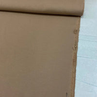 Camel brown cotton canvas upholstery fabric with a plain woven texture, ideal for curtains, cushions, chairs, sofas, furniture and outdoor projects.