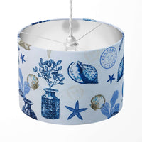 Lampshade with blue and white vintage nautical pattern on a white background.