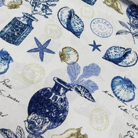 Coastal blue ocean upholstery fabric patterned with seashells, starfish, stamps.