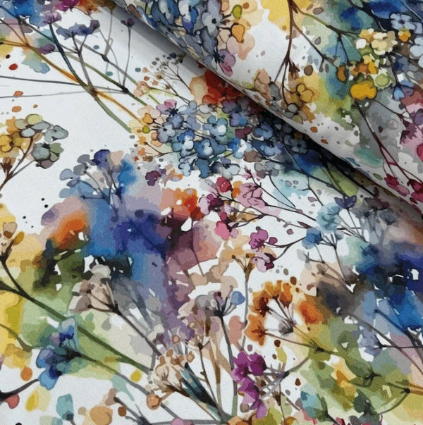 Colorful floral patterned fabric with watercolor style on a white background.