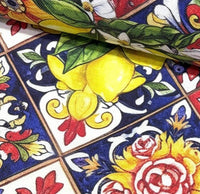 Close-up of colorful fabric with floral and fruit patterns.