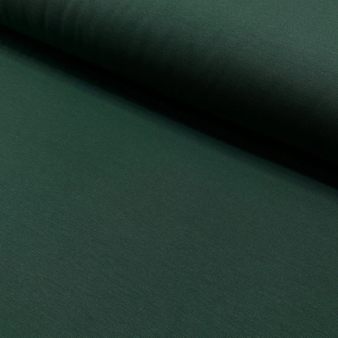 Dark forest green cotton canvas fabric with a plain woven texture, suitable for upholstery, curtains, cushions, bags, crafts, and soft furnishing projects.