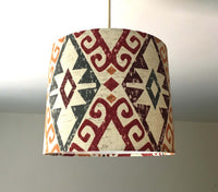 Decorative ceiling lampshade with geometric pattern on a plain background.