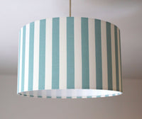Striped lampshade with duck egg and white vertical stripes on a plain background.