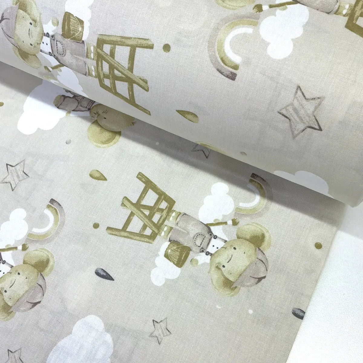 Beige elephant nursery 100% cotton poplin fabric featuring cute elephants, rainbows, clouds and stars for baby quilts, children's clothing and nursery décor.