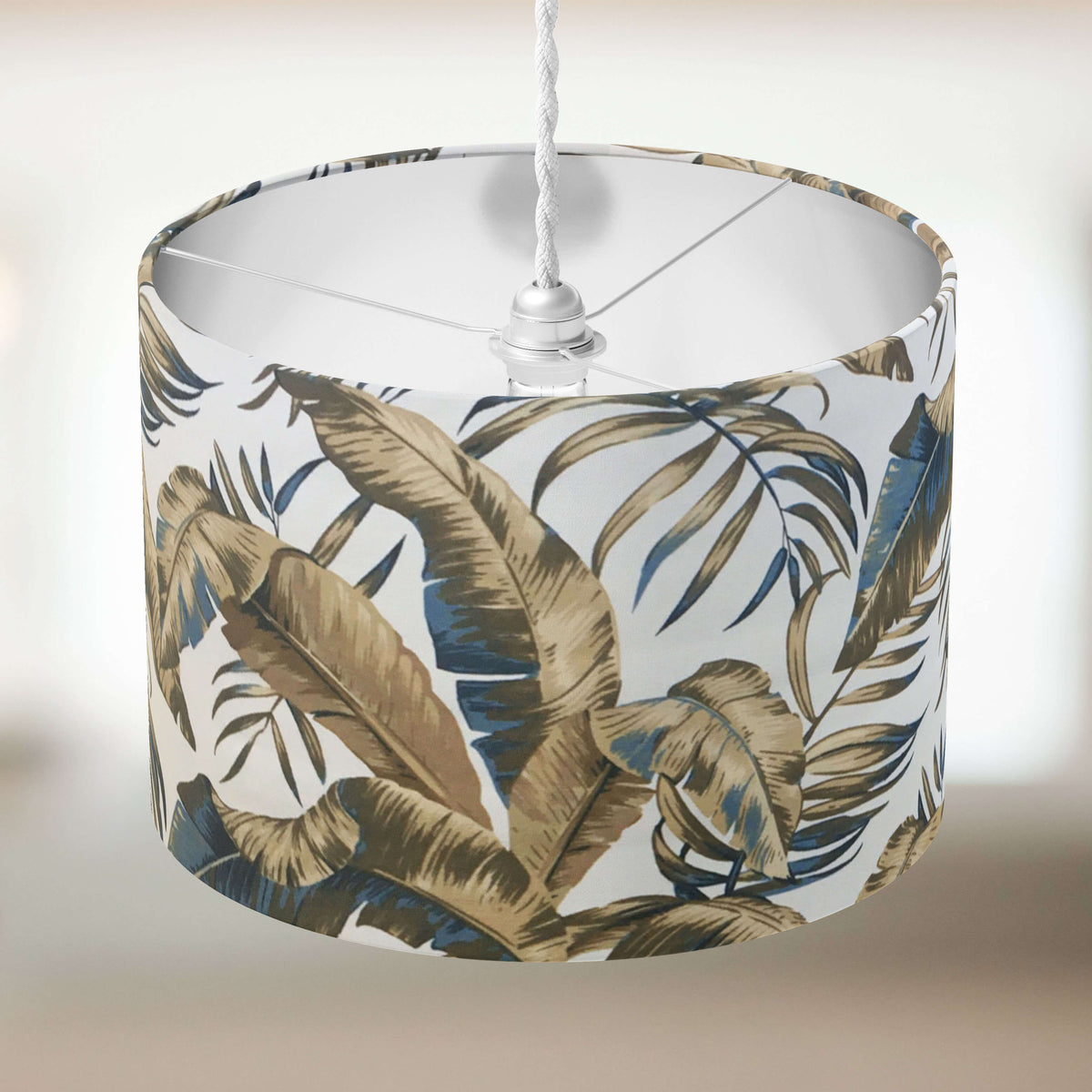 Brown ceiling lampshade with exotic leaf pattern on a white background.