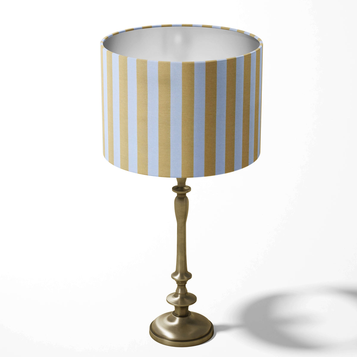 A lemon yellow and white vertical striped table lampshade.