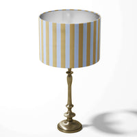 A lemon yellow and white vertical striped table lampshade.