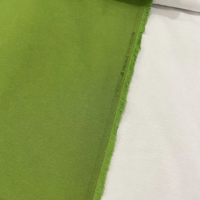 Grass green cotton canvas upholstery fabric with a plain woven texture, ideal for curtains, cushions, chairs, furniture and outdoor projects.