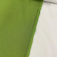 Grass green cotton canvas upholstery fabric with a plain woven texture, ideal for curtains, cushions, chairs, furniture and outdoor projects.