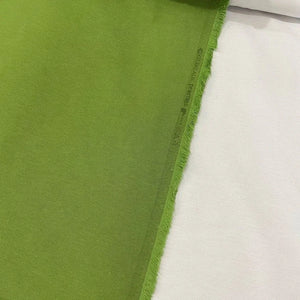 Grass green cotton canvas upholstery fabric with a plain woven texture, ideal for curtains, cushions, chairs, furniture and outdoor projects.