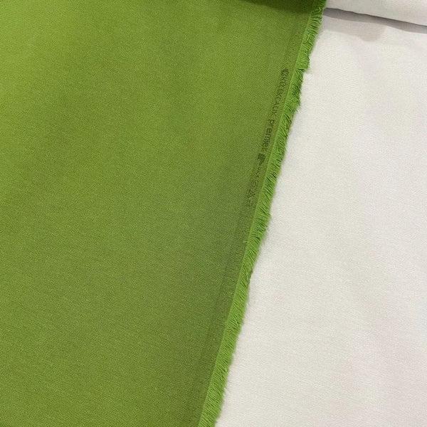 Grass green cotton canvas upholstery fabric with a plain woven texture, ideal for curtains, cushions, chairs, furniture and outdoor projects.