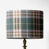Table lamp shade with a green plaid tartan pattern on a white background.