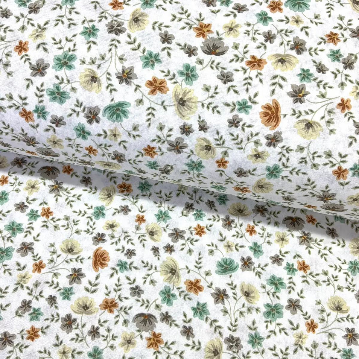 Floral patterned fabric with small sage green, mustard, beige and cream flowers and leaves on a white background.