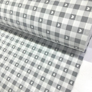 Grey cotton gingham fabric with white heart print, featuring a classic check pattern, ideal for dressmaking, quilting, patchwork and craft projects.