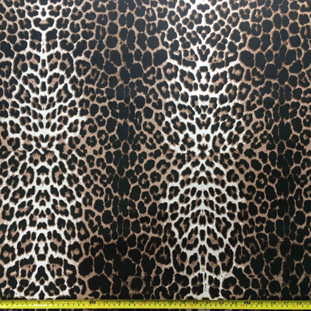 Leopard print fabric with a ruler at the bottom for scale.