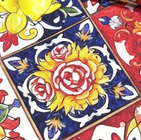 Close-up of a colorful fabric with floral patterns in red, yellow, and blue.