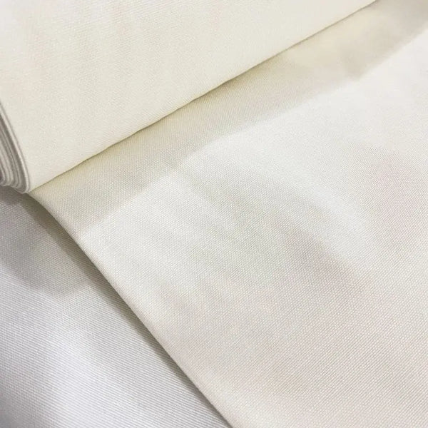 Ivory off white cotton canvas upholstery fabric with a plain woven texture, ideal for curtains, cushions, chairs, sofas, furniture and sewing projects.