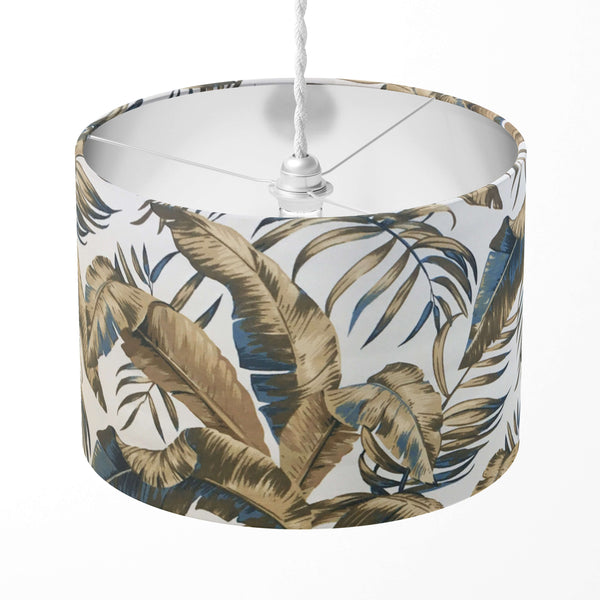Brown tropical leaf patterned lampshade on a white background.