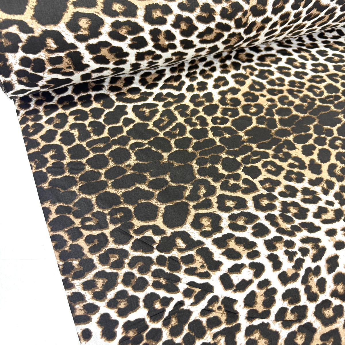 Brown leopard print cotton poplin fabric featuring a classic black and cream animal print, ideal for dressmaking, quilting, patchwork and sewing projects.