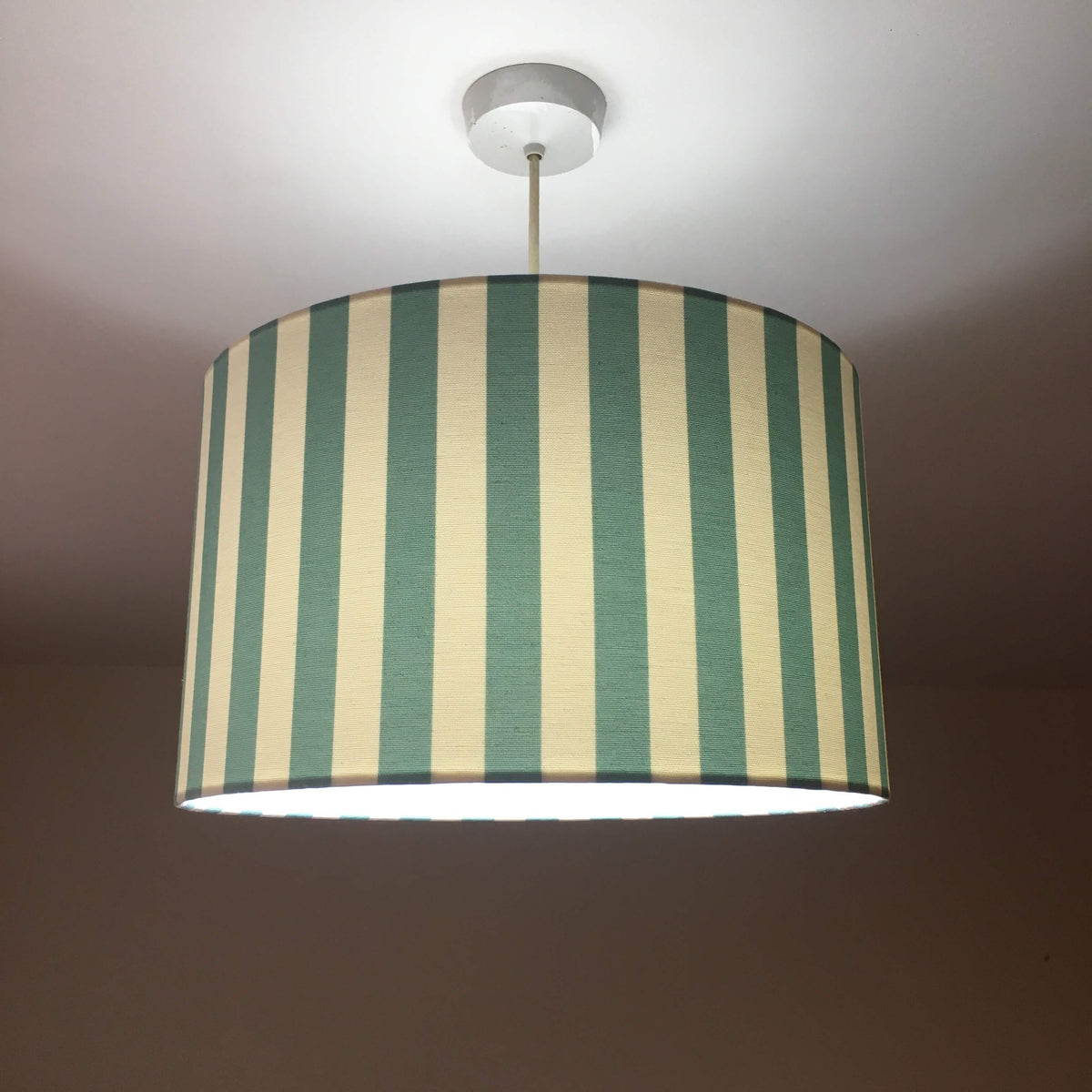 Mint green and white striped ceiling lampshade.