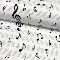 Music sheet fabric with black notes on a white background.