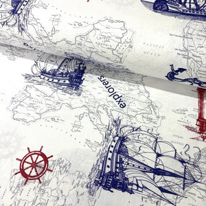Nautical cotton fabric featuring an antique world map, explorer sailing ships, compass wheel motifs, and marine illustrations in navy blue and red on an off-white background.