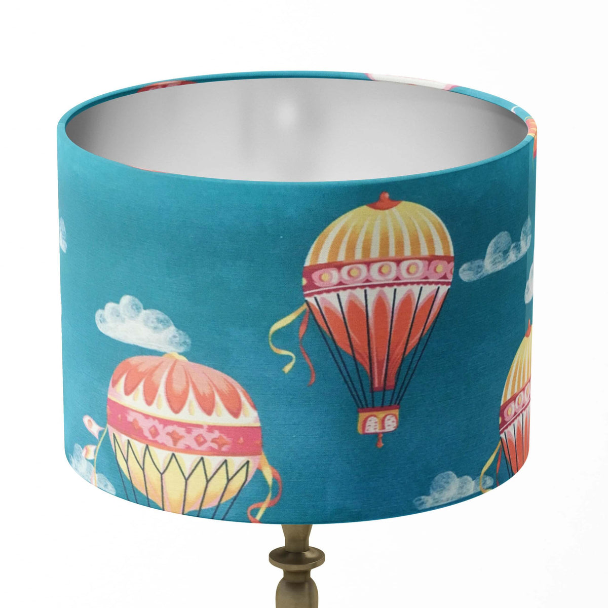 Drum table and floor lamp shade with hot air balloon design on a blue background.