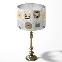 Forest animal patterned kids nursery room table lampshade in white, yellow, blue and black.
