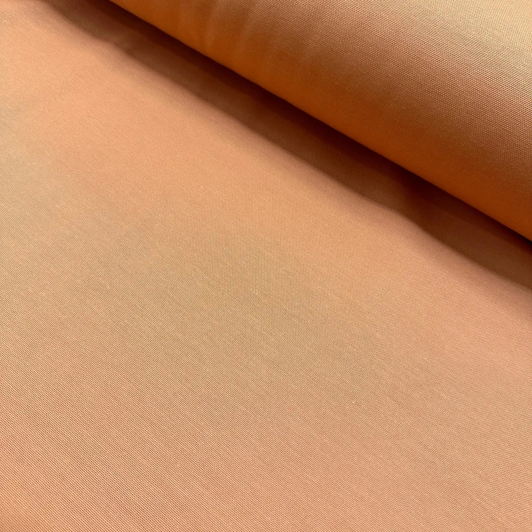 Peach cotton duck canvas fabric with a durable plain woven texture, suitable for upholstery, curtains, cushions, bags, crafts, and soft furnishing projects.
