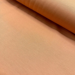 Peach cotton duck canvas fabric with a durable plain woven texture, suitable for upholstery, curtains, cushions, bags, crafts, and soft furnishing projects.