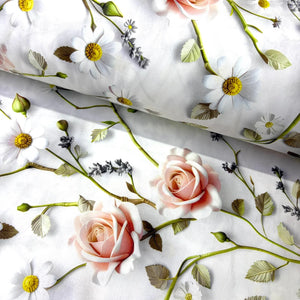 White cotton poplin fabric with a floral print featuring pink roses, white daisies with yellow centers, and green leaves.