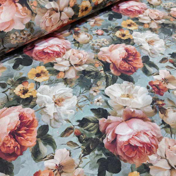 Close-up of floral fabric with pink, white, and yellow roses on a duck egg background.