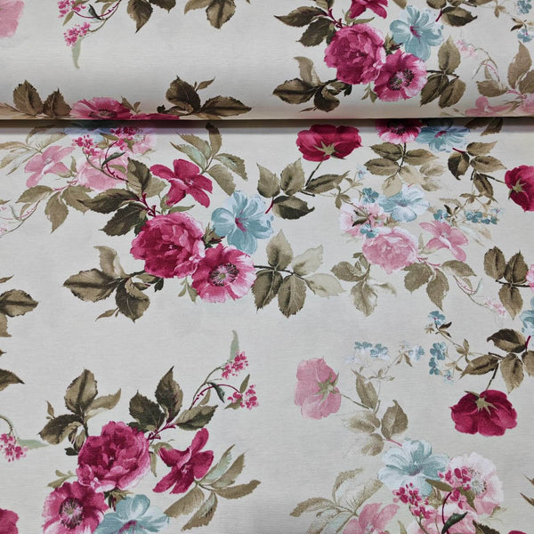 Floral upholstery fabric with fuchsia pink and blue flowers and sage green leaves on a white background.