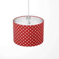 Red ceiling lampshade with white polka dots on a white background.