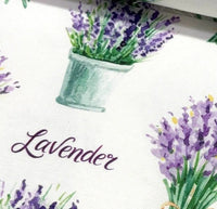 Decorative cotton canvas upholstery fabric with lavender design and text on a white background.