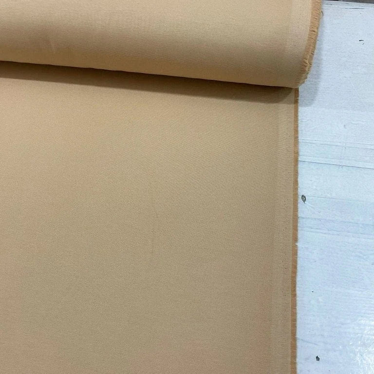 Sand beige cotton canvas fabric with a durable plain woven texture, ideal for upholstery, curtains, cushions, bags and craft projects.
