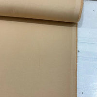 Sand beige cotton canvas fabric with a durable plain woven texture, ideal for upholstery, curtains, cushions, bags and craft projects.